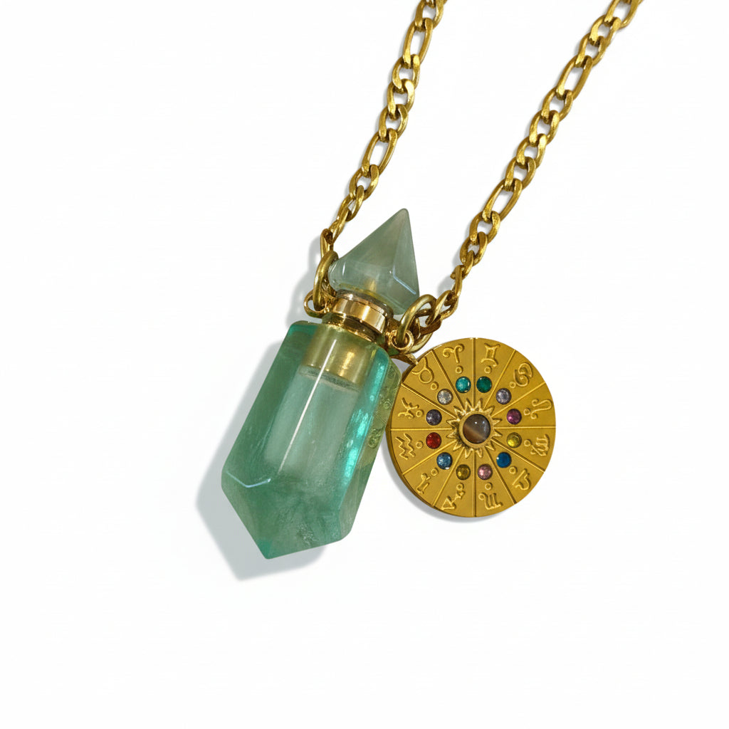 Zodiac clock necklace with green flourite crystal pendant  bottle for perfume oil and gold chain on beige background