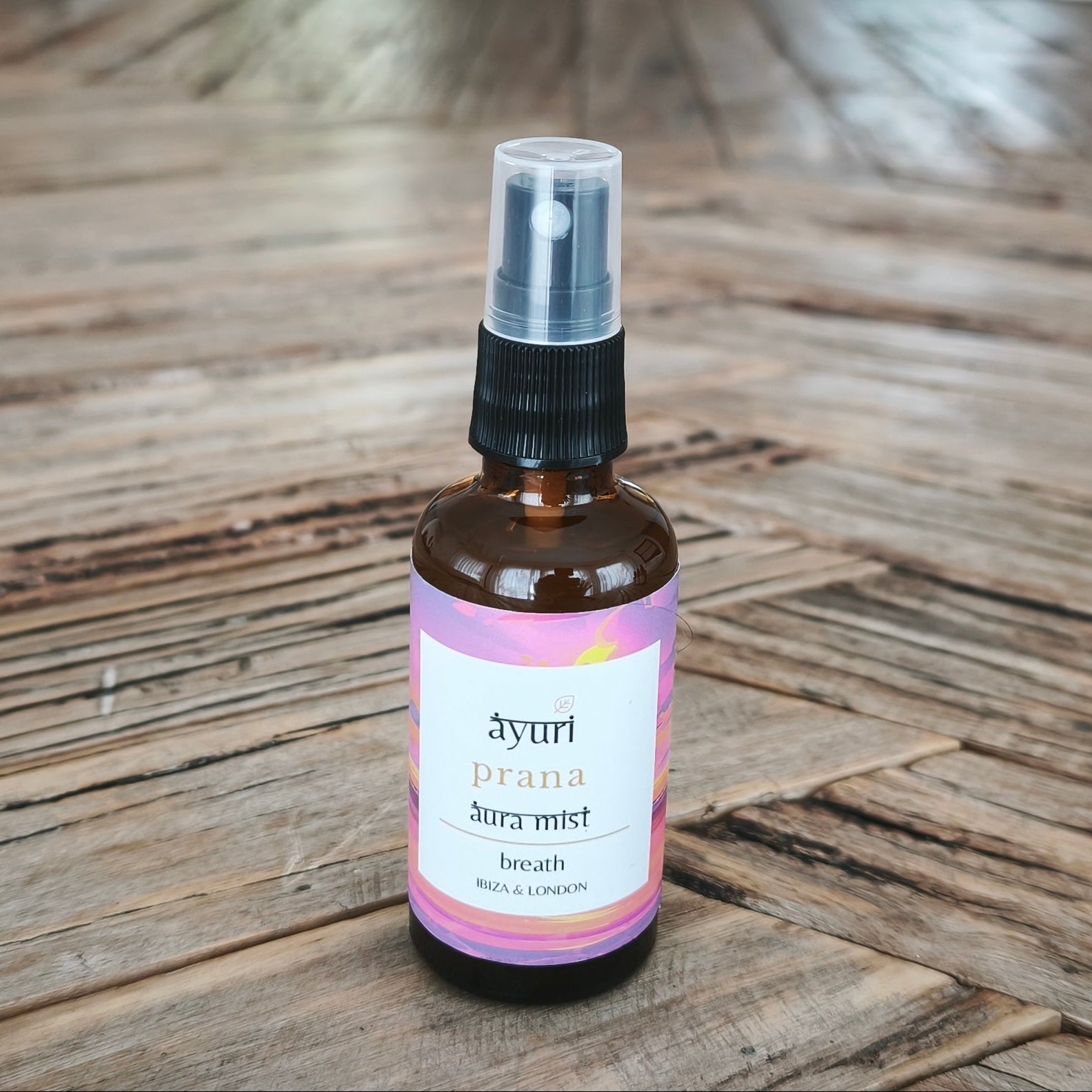 Bottle of aromatherapy essential oil mist on a wooden table
