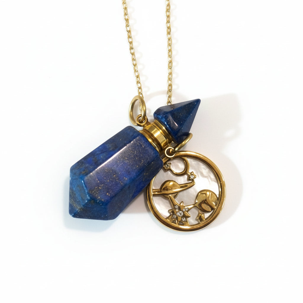 Cosmos necklace with blue lapiz lazuli pendant perfume oil bottle and gold chain on beige background