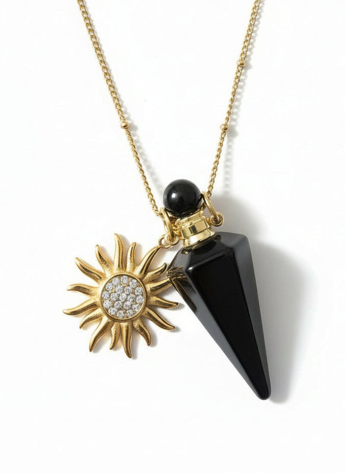 Obsidian crystal pendant perfume bottle Necklace with a black cone and sunflower pendant on a mannequin bust.