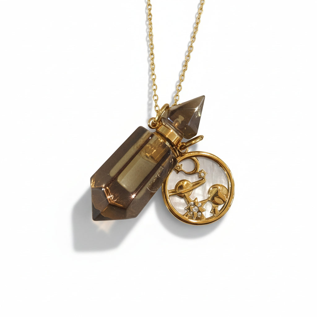 Smokey quarts crystal perfume pendant bottle with golds cosmos charm on a gold chian