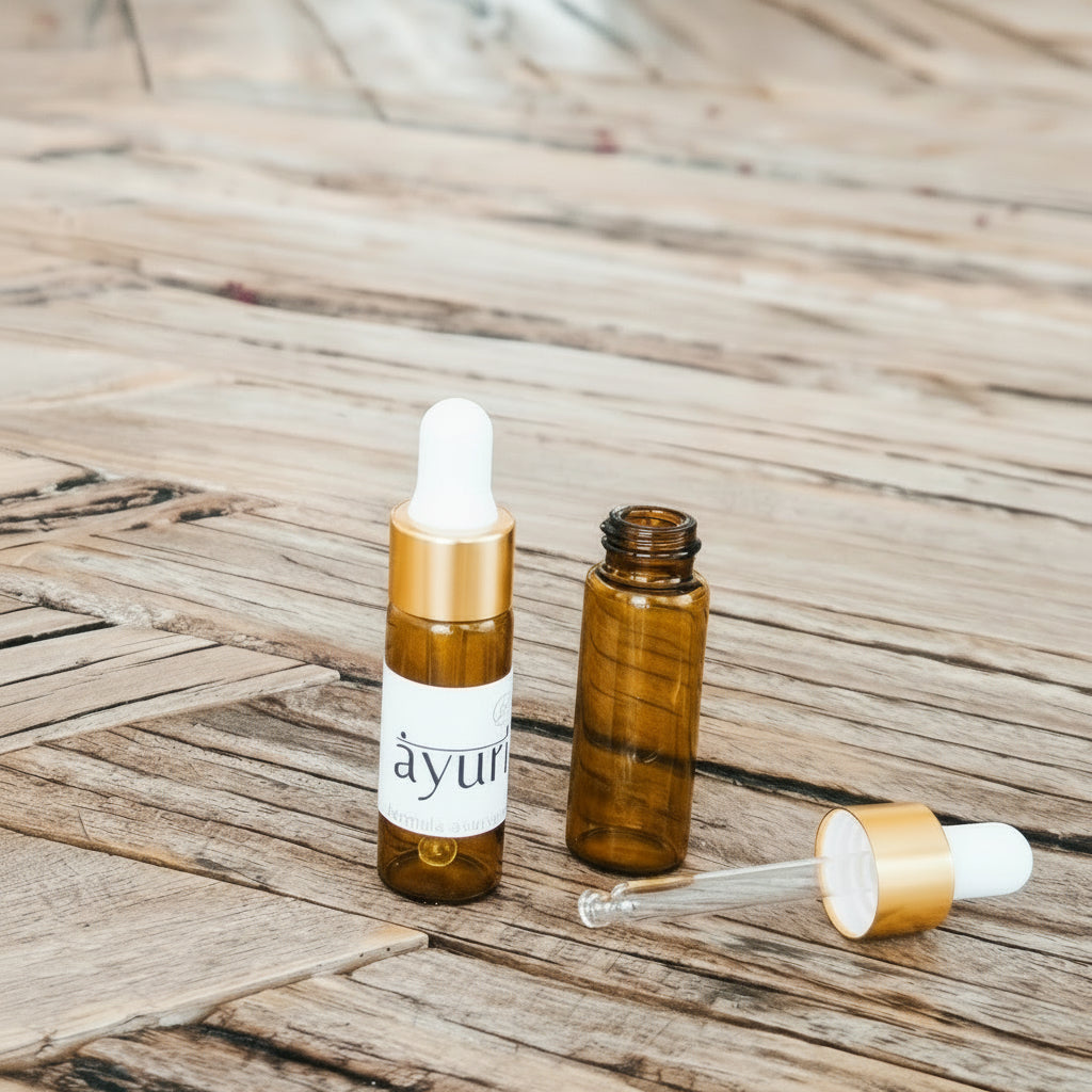 Hand blended ayurvedic aroma oil roller bottles on a wooden table with a blurred background