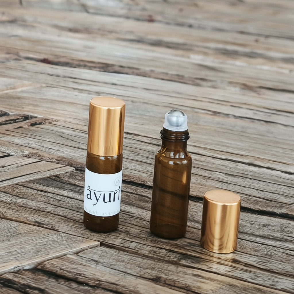 hand blended aroma oil roller bottles on a wooden table with a blurred background